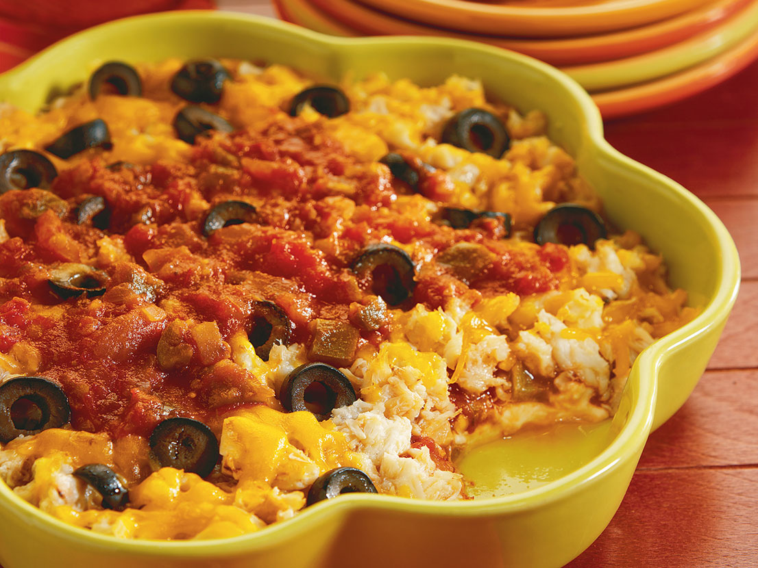 An image of prepared Double Cheese Crab Dip made with Pace® Picante Sauce, chili powder, cream cheese, crabmeat, Cheddar cheese and black olives.