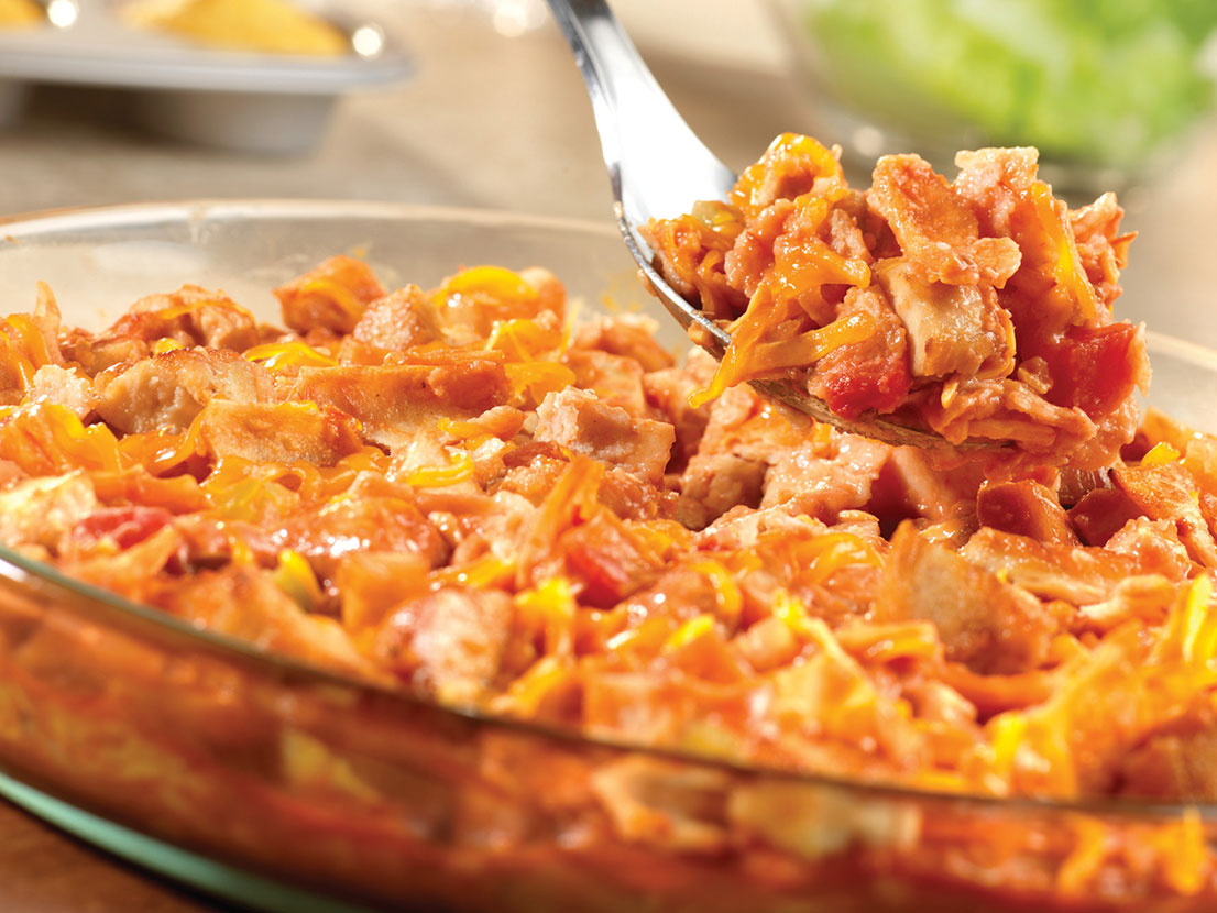 An image of prepared E-Z Chicken Tortilla Bake made with Campbell's® Condensed Tomato Soup, Pace® Chunky Salsa, milk, chicken, tortillas and Cheddar cheese.