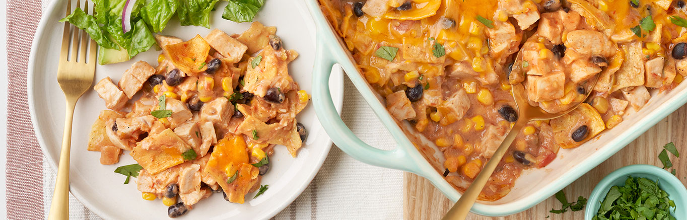 An image of prepared Cowboy Chicken Casserole showing Campbell's® Condensed Cream of Chicken Soup, Pace® Chunky Salsa, black beans, corn, cooked chicken, flour or corn tortillas and Cheddar cheese.