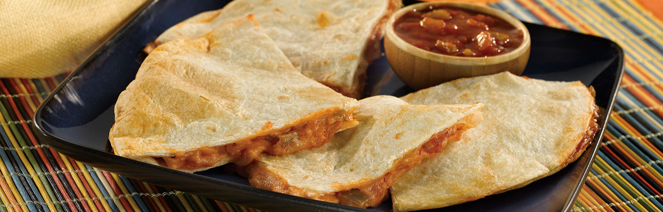 An image of prepared Cheesy Picante Quesadillas made with flour tortillas, Pace® Picante Sauce, green chiles and Monterey Jack cheese.