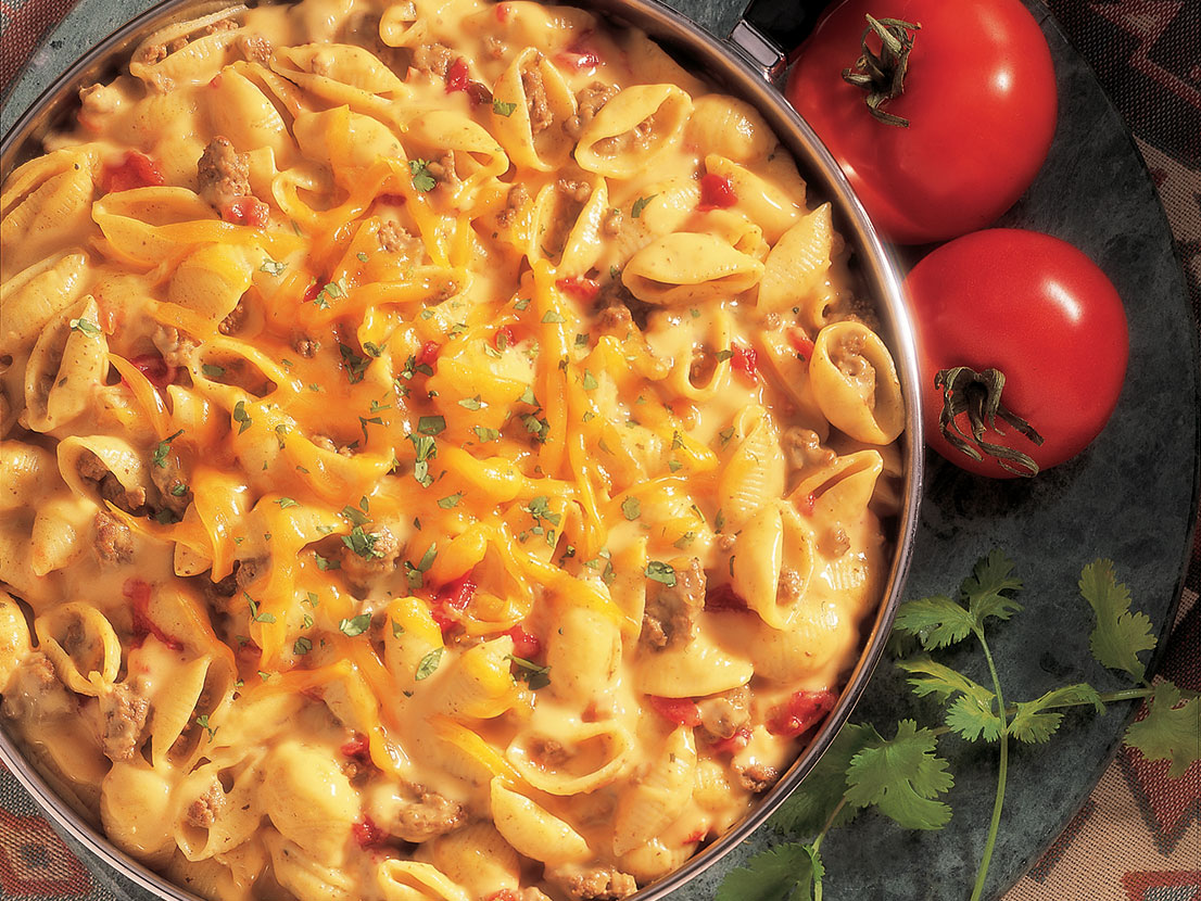 An image of prepared Cheesy Picante Mac & Beef made with ground beef, Swanson® Beef Broth, shell pasta, Campbell's® Condensed Cheddar Cheese Soup and Pace® Picante Sauce.