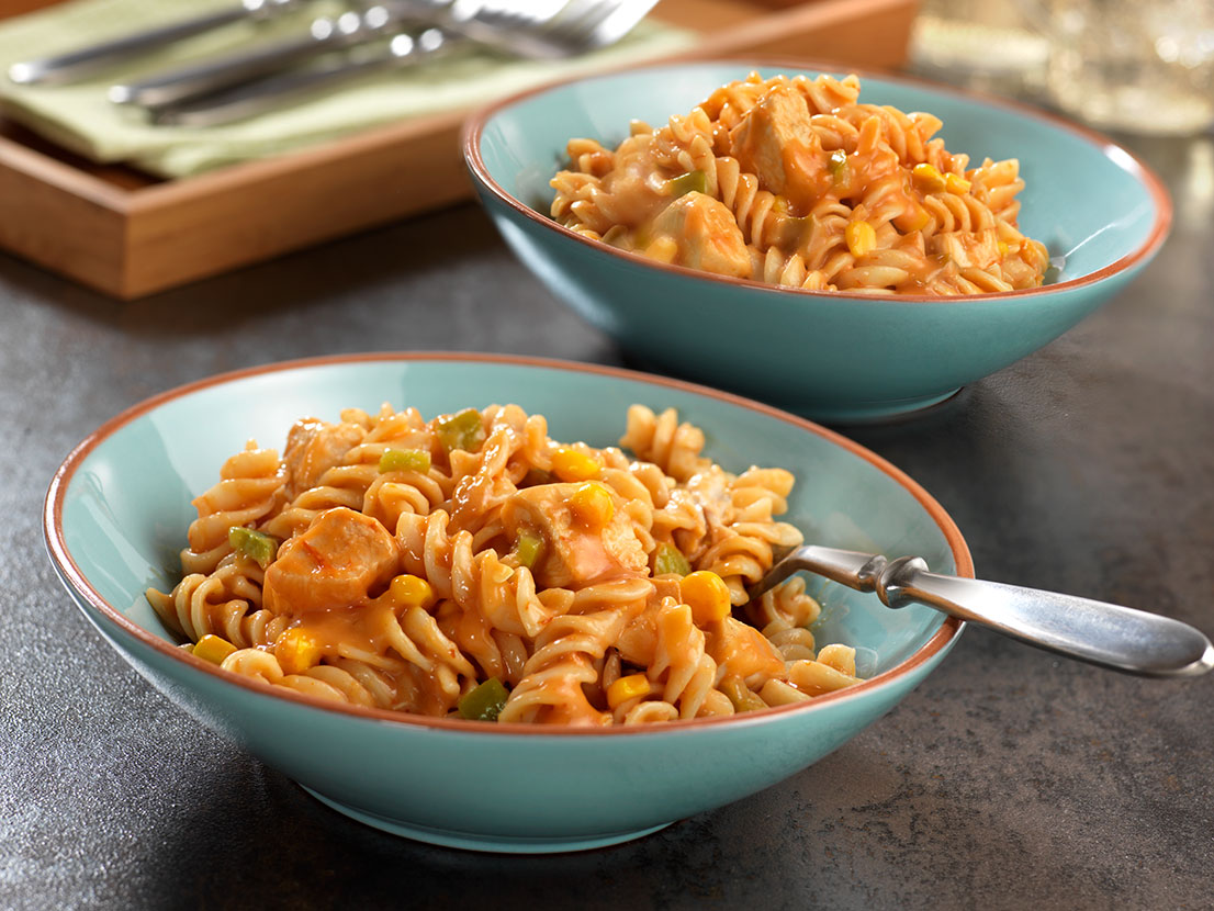 An image of prepared Cheesy Rotini & Chicken Skillet made with chicken, Campbell's® Condensed Cheddar Cheese Soup, Pace® Picante Sauce, corn and Cheddar cheese.