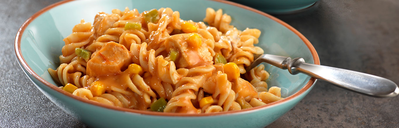 An image of prepared Cheesy Rotini & Chicken Skillet made with chicken, Campbell's® Condensed Cheddar Cheese Soup, Pace® Picante Sauce, corn and Cheddar cheese.