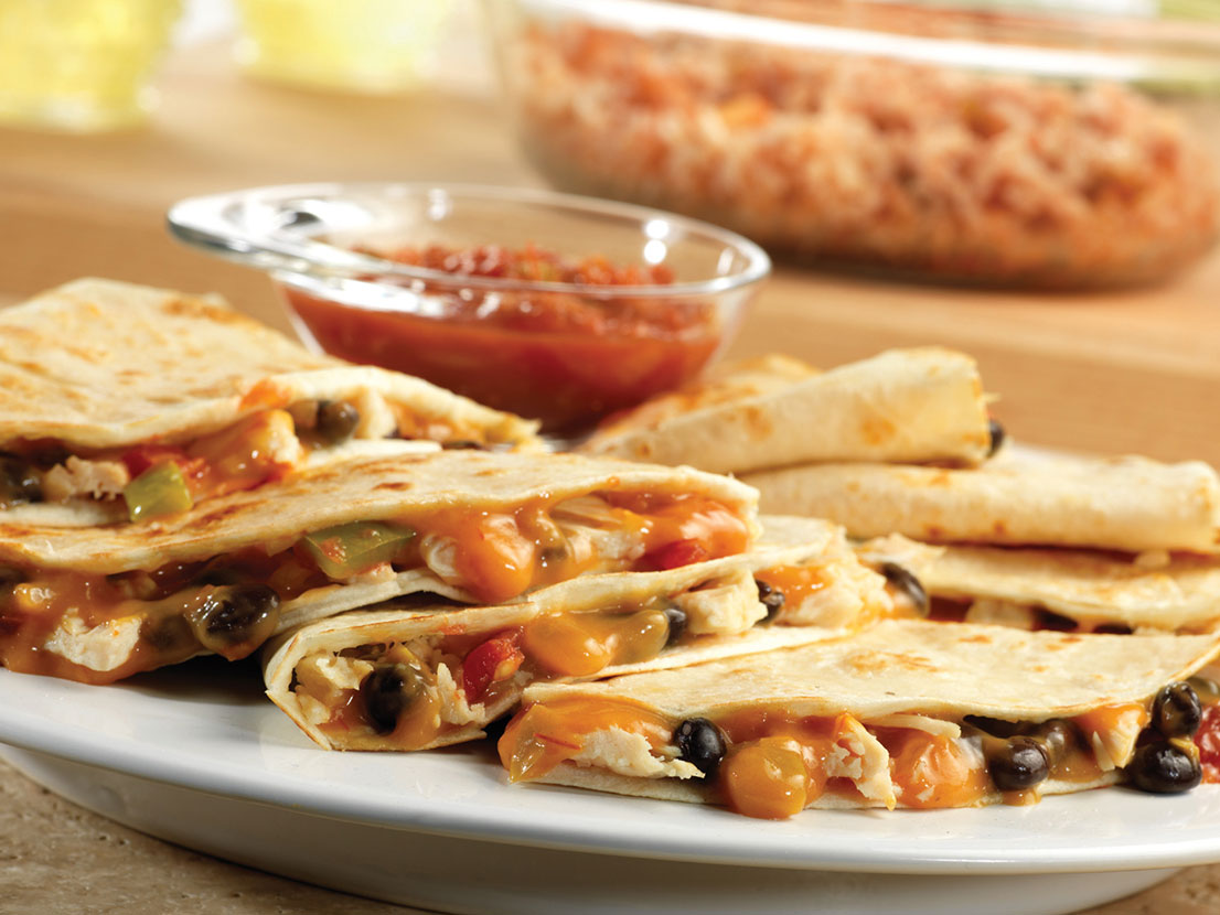 An image of prepared Chicken & Black Bean Quesadillas made with Campbell's® Condensed Cheddar Cheese Soup, Pace® Chunky Salsa, black beans, Swanson® Premium White Chunk Chicken and flour tortillas.