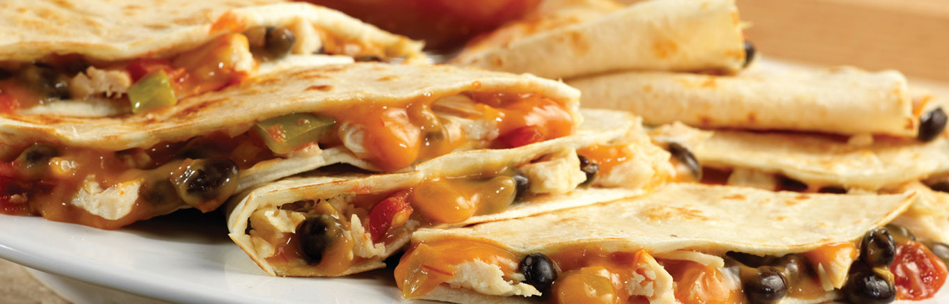 An image of prepared Chicken & Black Bean Quesadillas made with Campbell's® Condensed Cheddar Cheese Soup, Pace® Chunky Salsa, black beans, Swanson® Premium White Chunk Chicken and flour tortillas.