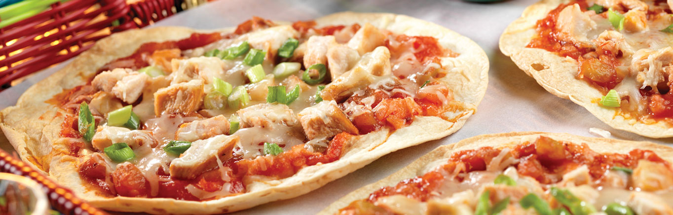 An image of prepared Chicken Picante Pizzas made with flour tortillas, Pace® Picante Sauce, chicken, Monterey Jack cheese and green onions.