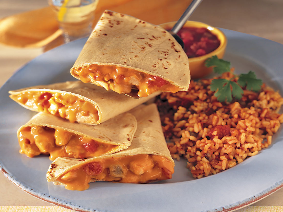 An image of prepared Chicken Quesadillas & Fiesta Rice made with chicken, Campbell's® Condensed Cheddar Cheese Soup, Pace® Picante Sauce, flour tortillas, Campbell's Condensed Chicken Broth and rice.