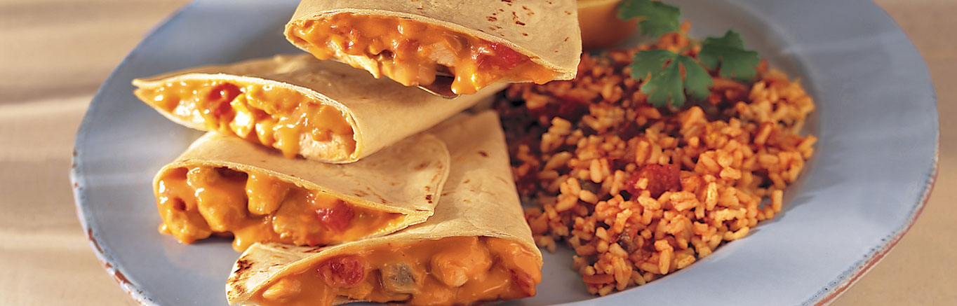 An image of prepared Chicken Quesadillas & Fiesta Rice made with chicken, Campbell's® Condensed Cheddar Cheese Soup, Pace® Picante Sauce, flour tortillas, Campbell's Condensed Chicken Broth and rice.
