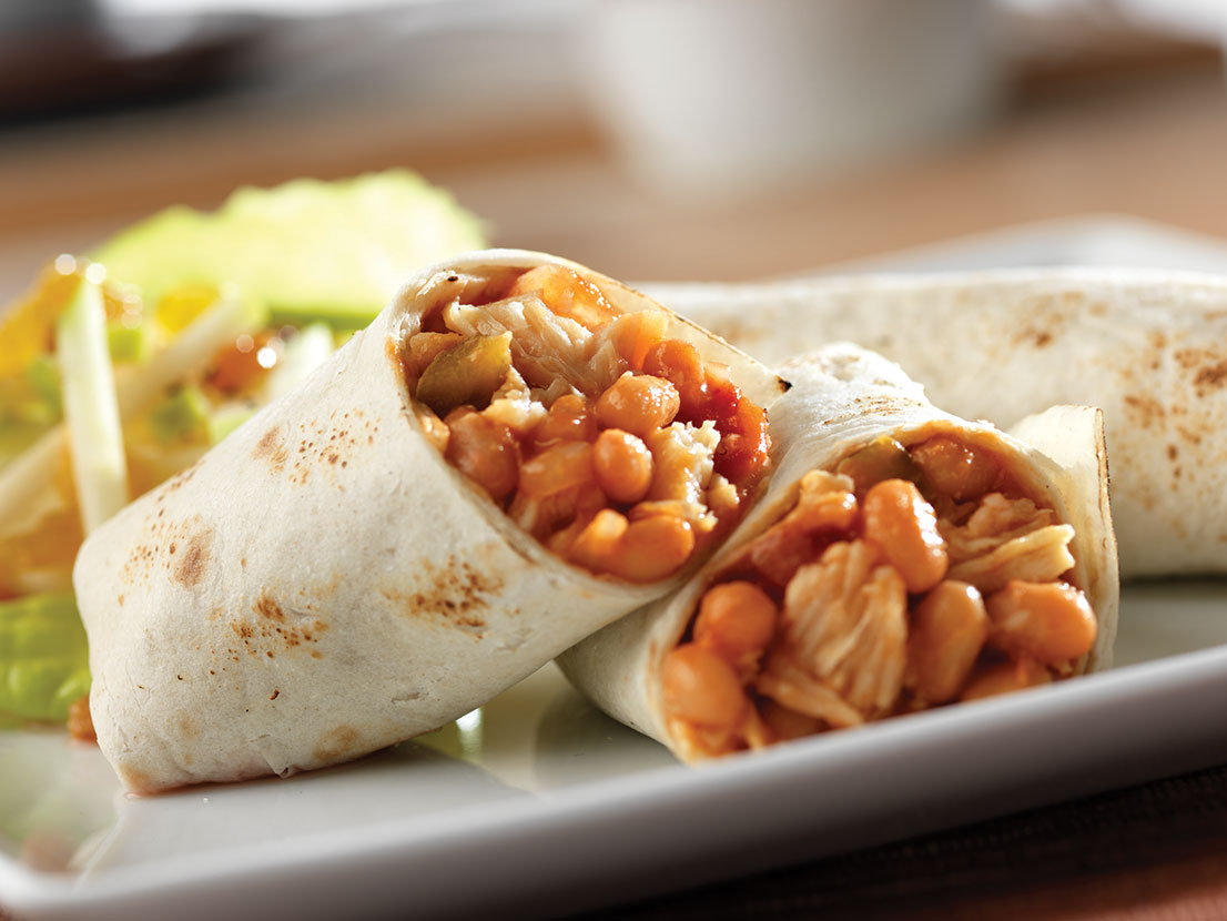 An image of prepared Chicken and Bean Burritos made with onion, Campbell's Condensed Bean with Bacon Soup, Pace® Chunky Salsa, Swanson® Premium White Chunk Chicken and tortillas.