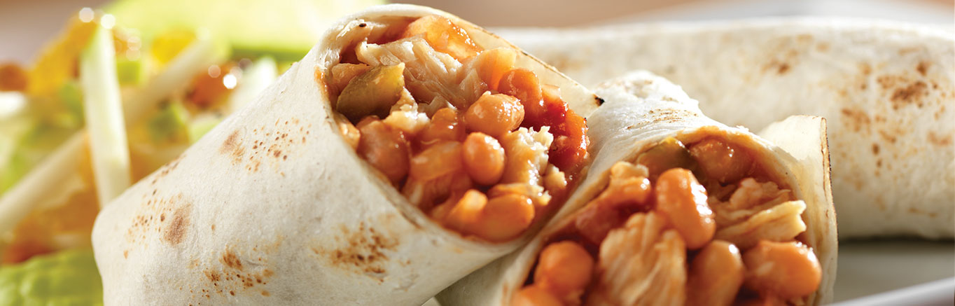 An image of prepared Chicken and Bean Burritos made with onion, Campbell's Condensed Bean with Bacon Soup, Pace® Chunky Salsa, Swanson® Premium White Chunk Chicken and tortillas.
