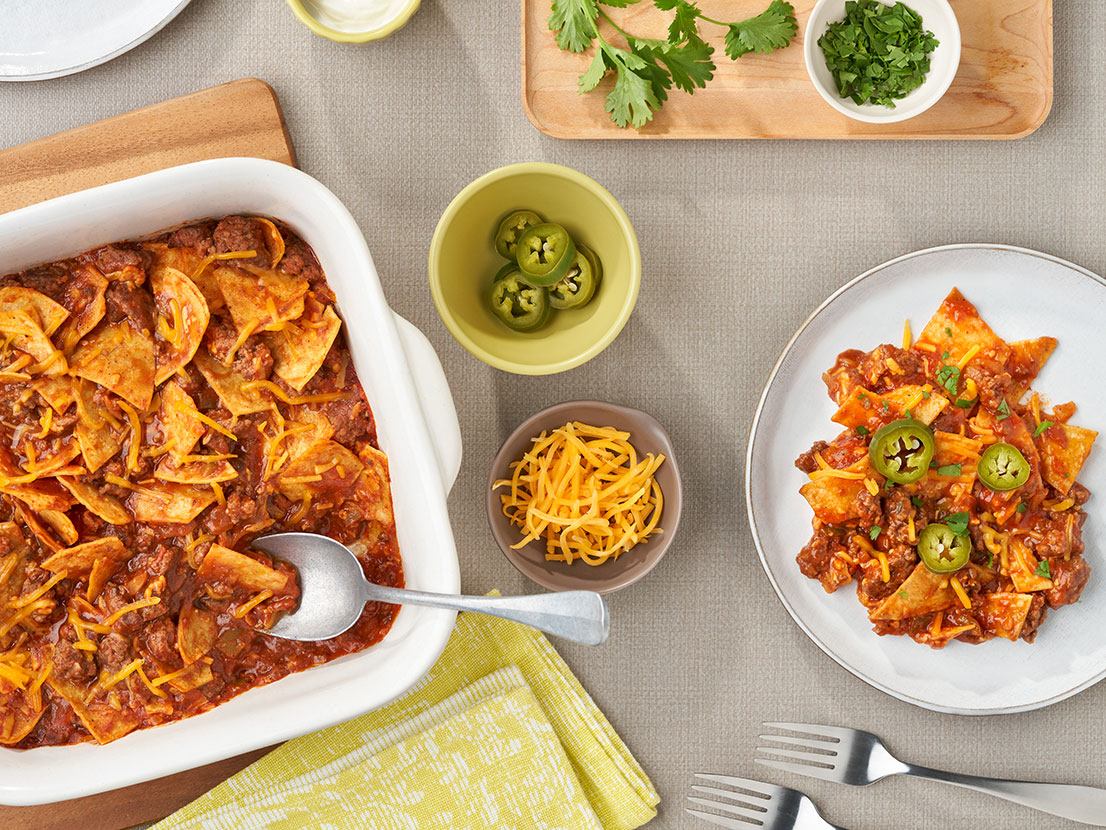 An image of prepared Easy Beef Taco Bake showing ground beef, Campbell's® Condensed Tomato Soup, Pace® Picante Sauce, corn or flour tortillas and melted Cheddar cheese.