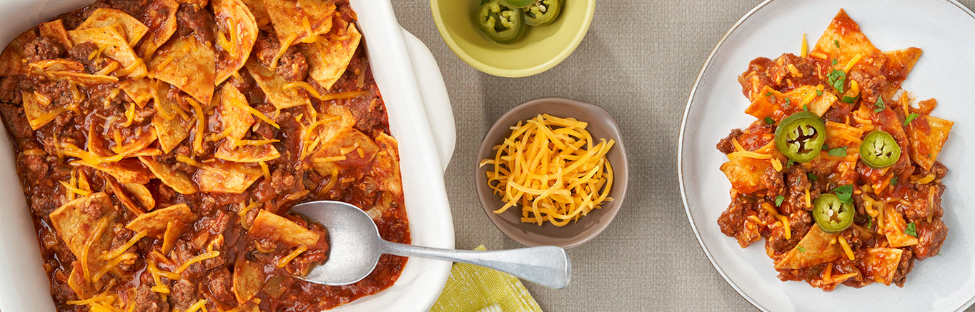 An image of prepared Easy Beef Taco Bake showing ground beef, Campbell's® Condensed Tomato Soup, Pace® Picante Sauce, corn or flour tortillas and melted Cheddar cheese.
