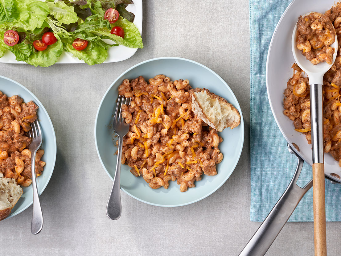 An image of prepared Easy Goulash (Skillet Beef & Macaroni) showing elbow macaroni, ground beef, Campbell's® Condensed Cream of Mushroom Soup, Pace® Picante Sauce and Cheddar cheese.