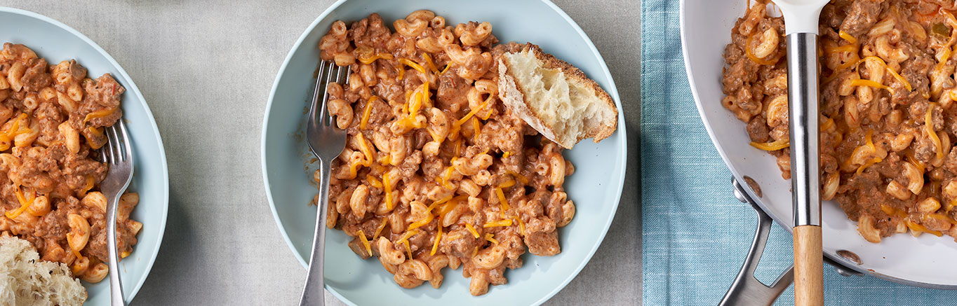 An image of prepared Easy Goulash (Skillet Beef & Macaroni) showing elbow macaroni, ground beef, Campbell's® Condensed Cream of Mushroom Soup, Pace® Picante Sauce and Cheddar cheese.