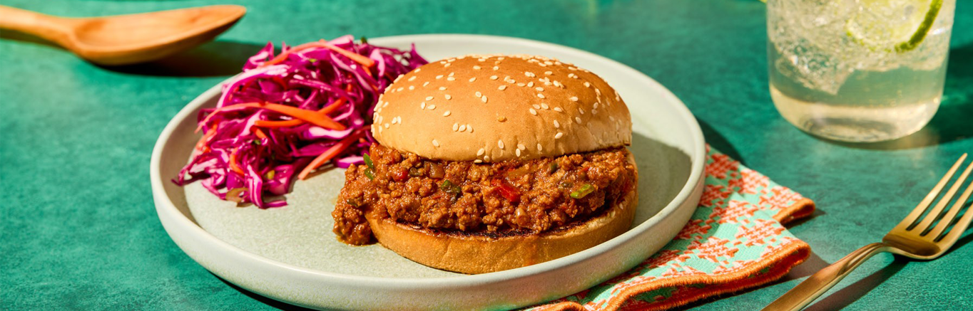 An image of prepared Picante Sloppy Joes made with ground beef, Pace® Picante Sauce or Chipotle Picante Sauce, brown sugar, mustard, green onion and Pepperidge Farm® Sesame Topped Hamburger Buns.