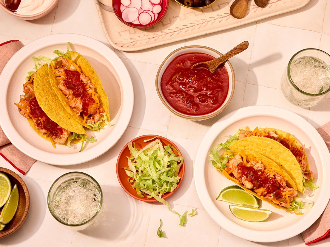 An image of prepared Quick Chicken Tacos made with Swanson® Premium Chicken Breast in Water, Pace® Picante Sauce, lettuce, taco shells and Cheddar cheese.