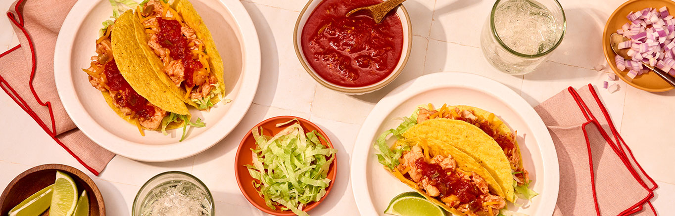 An image of prepared Quick Chicken Tacos made with Swanson® Premium Chicken Breast in Water, Pace® Picante Sauce, lettuce, taco shells and Cheddar cheese.