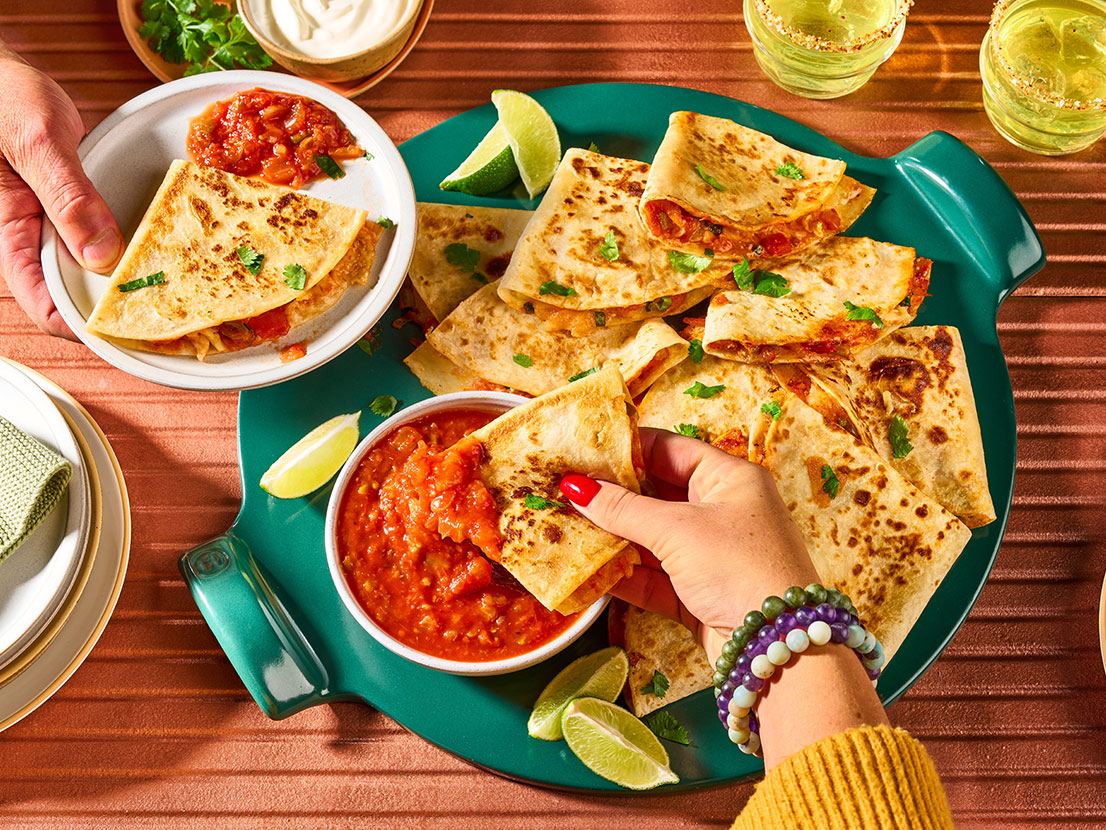 An image of prepared Quick Quesadillas made with flour tortillas, Monterey Jack cheese, green onion and Pace® Picante Sauce.