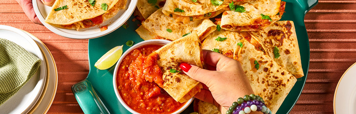 An image of prepared Quick Quesadillas made with flour tortillas, Monterey Jack cheese, green onion and Pace® Picante Sauce.