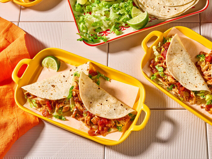 An image of prepared Slow Cooked Chicken Tacos made with chicken, Pace® Picante Sauce and flour tortillas.