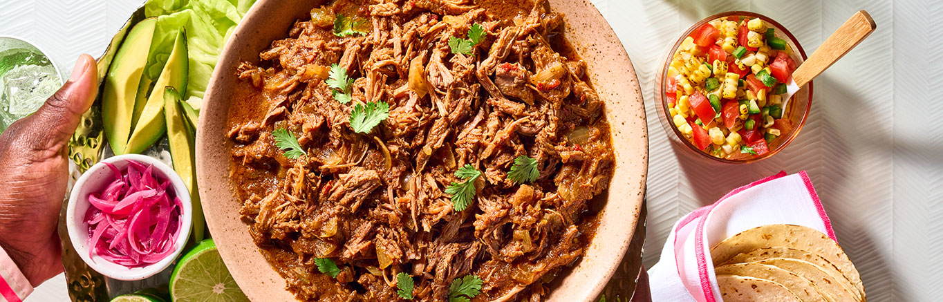 An image of prepared 4-Ingredient Slow Cooker Mexican Beef made with beef chuck roast, onion, Pace® Chunky Salsa and chipotle peppers.