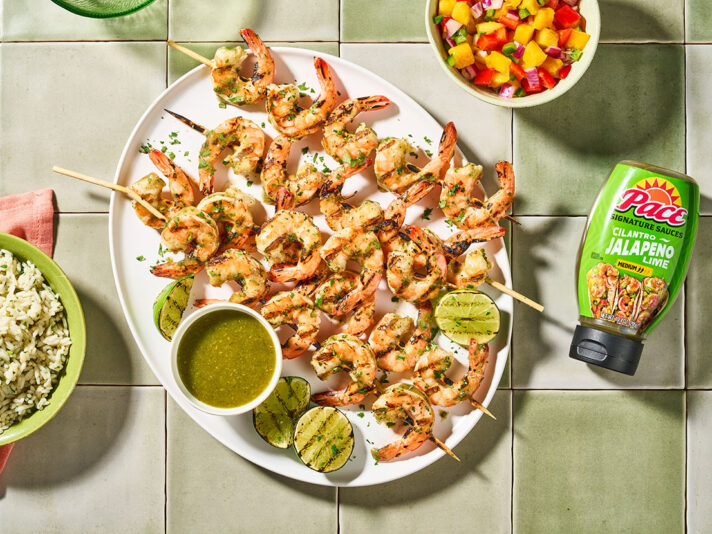 An image of prepared Grilled Cilantro Jalapeño Lime Shrimp Skewers made with Pace® Signature Sauces Cilantro Jalapeño Lime Sauce, cilantro, shrimp and white rice.