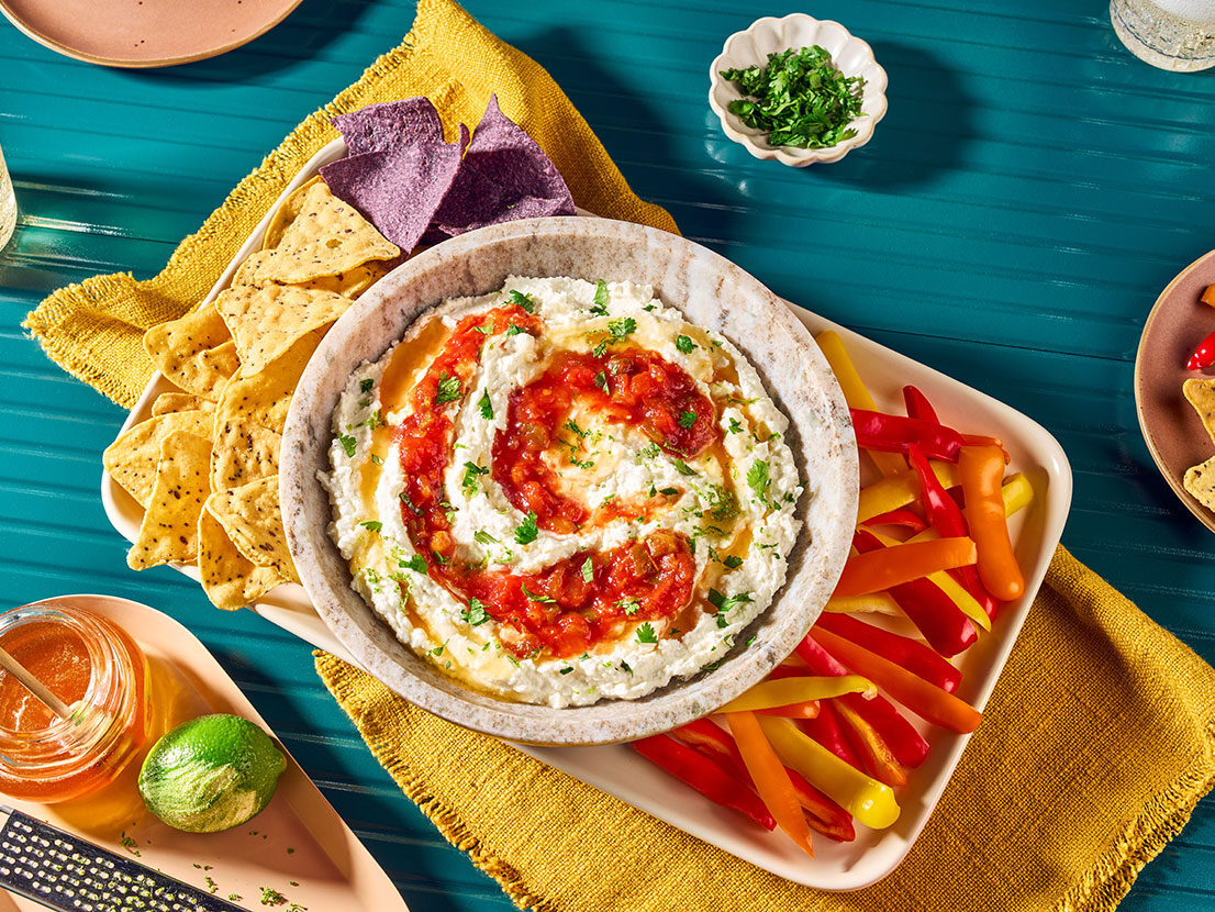 An image of prepared Whipped Feta Dip with Salsa & Honey made with feta, Greek yogurt, Pace® Chunky Salsa, honey and cilantro served with tortilla chips.