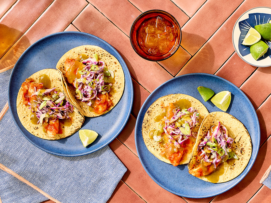 An image of prepared Cajun Chicken Tacos with Jalapeño Cilantro Lime Slaw made with Pace® Signature Sauces Cilantro Jalapeño Lime Sauce, red cabbage, chicken, Cajun seasoning, Pace® Chunky Salsa and corn tortillas.