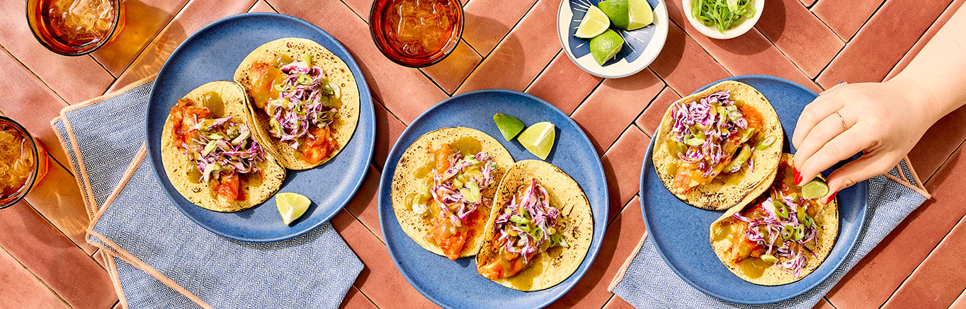 An image of prepared Cajun Chicken Tacos with Jalapeño Cilantro Lime Slaw made with Pace® Signature Sauces Cilantro Jalapeño Lime Sauce, red cabbage, chicken, Cajun seasoning, Pace® Chunky Salsa and corn tortillas.