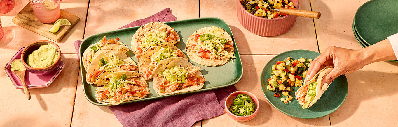 An image of prepared Cilantro Jalapeño Lime Chicken Tacos made with avocado, Pace® Signature Sauces Cilantro Jalapeño Lime Sauce, cilantro, green cabbage, chicken, Pace® Picante Sauce and corn tortillas.