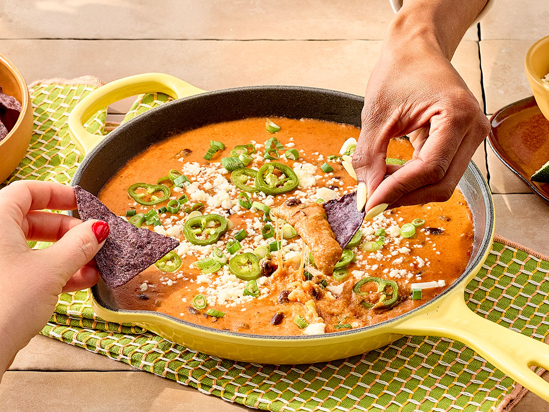 An image of prepared Easy Queso & Bean Dip made with Pace® Picante Sauce, Pace® Signature Sauces Classic Taco Sauce, black beans, Pace® Queso Blanco Dip, Monterey Jack cheese and cotija cheese.