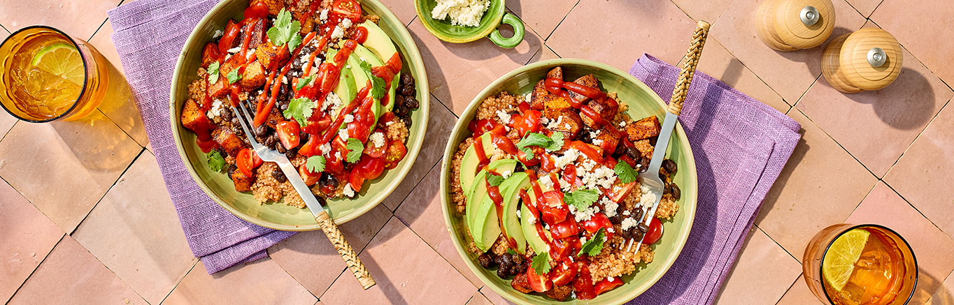 An image of prepared Vegetarian Grain Bowls made with sweet potatoes, black beans, onion, quinoa, Pace® Chunky Salsa, avocado, cherry tomatoes, Pace® Classic Taco Signature Sauce and queso fresco.