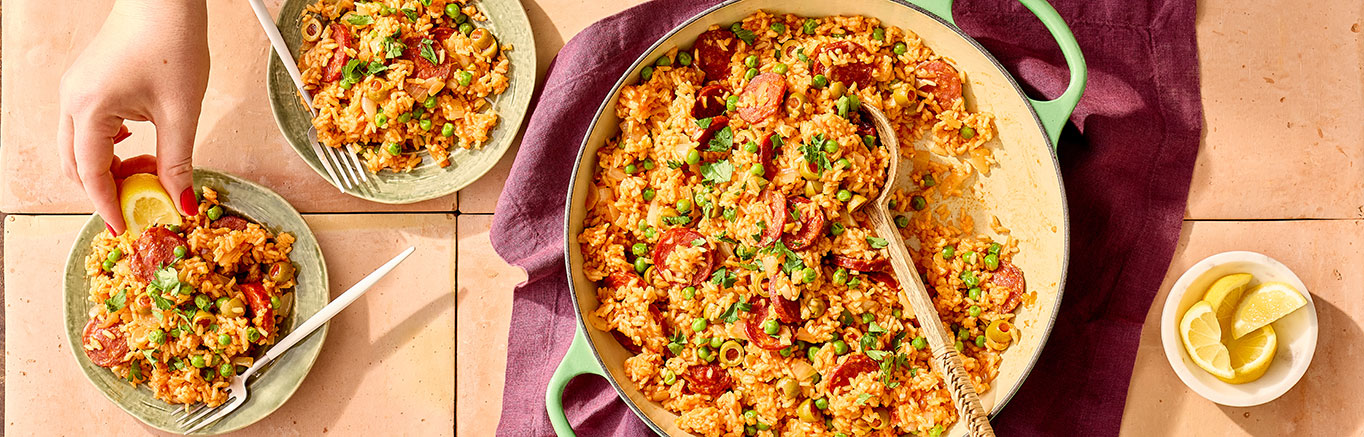 An image of prepared Chorizo & Rice Paella made with dried chorizo, white rice, Swanson® chicken broth, Pace® Picante Sauce, olives, Pace® Hot Honey Chipotle Signature Sauce and peas.