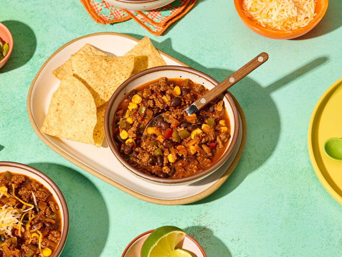 An image of prepared Easy Chipotle Beef Chili made with onion, green bell pepper, ground beef, Pace® Chipotle Picante Sauce, Swanson® 50% Less Sodium Beef Broth, black beans and corn.