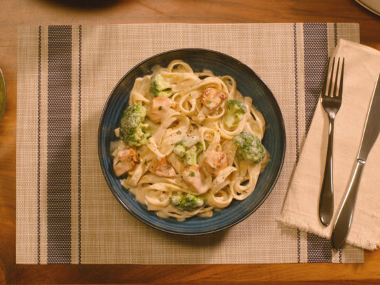 An image of prepared Chicken Alfredo made with chicken, Prego® Roasted Garlic Parmesan Alfredo Sauce or Homestyle Alfredo Pasta Sauce, fettuccine and broccoli.
