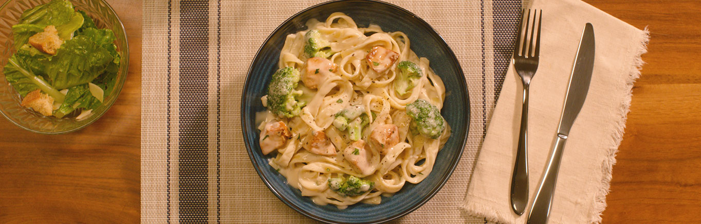 An image of prepared Chicken Alfredo made with chicken, Prego® Roasted Garlic Parmesan Alfredo Sauce or Homestyle Alfredo Pasta Sauce, fettuccine and broccoli.