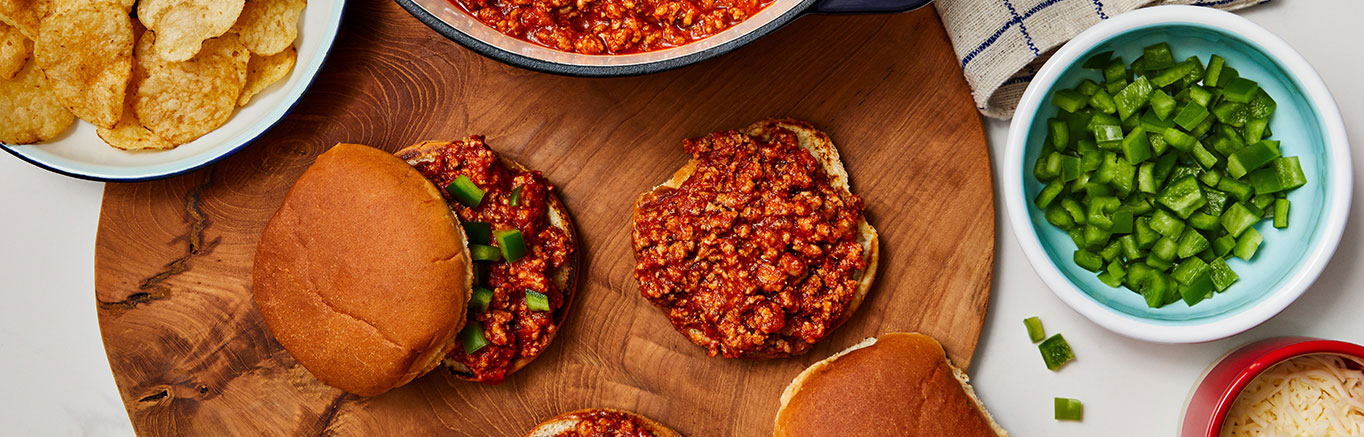An image of prepared Easy Italian-Style Sloppy Joes made with ground beef or ground turkey, Prego® Traditional Italian Sauce, mozzarella cheese and Pepperidge Farm® Soft White Hamburger Buns.