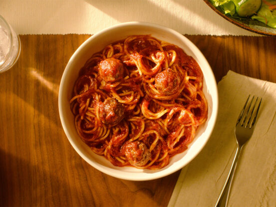 An image of prepared Quick Spaghetti & Meatballs made with spaghetti, Prego® Traditional Italian Sauce, meatballs and Parmesan cheese.