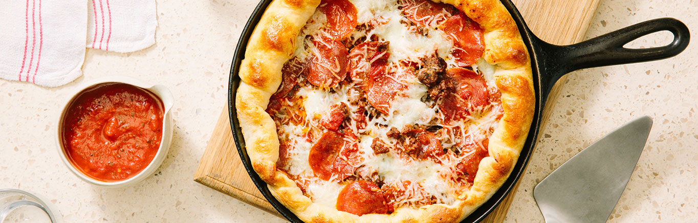 An image of prepared Homemade Deep Dish Pizza with Beef, Pepperoni & Peppers made with ground beef, peppers, onions, Prego® Traditional Sauce, pepperoni and pizza cheese blend.
