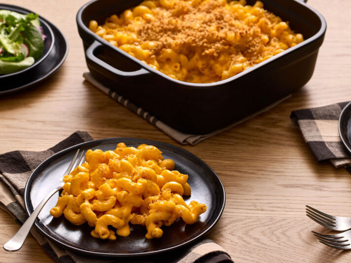 An image of prepared Baked Mac & Cheese made with Prego® Creamy Cheddar Sauce, cavatappi pasta, Cheddar cheese and panko.