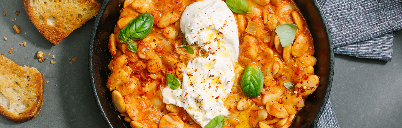 An image of prepared Beans alla Vodka with Burrata made with Prego® Spicy Vodka Sauce, onion, garlic, butter beans, cannellini beans, basil and burrata cheese.