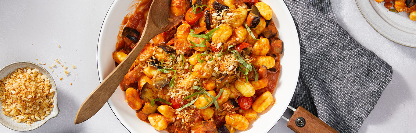 An image of prepared Creamy Tomato Gnocchi with Eggplant made with Prego® Creamy Tomato with Ricotta Sauce, Parmesan cheese, eggplant, onion, cherry tomatoes, garlic and photo gnocchi.
