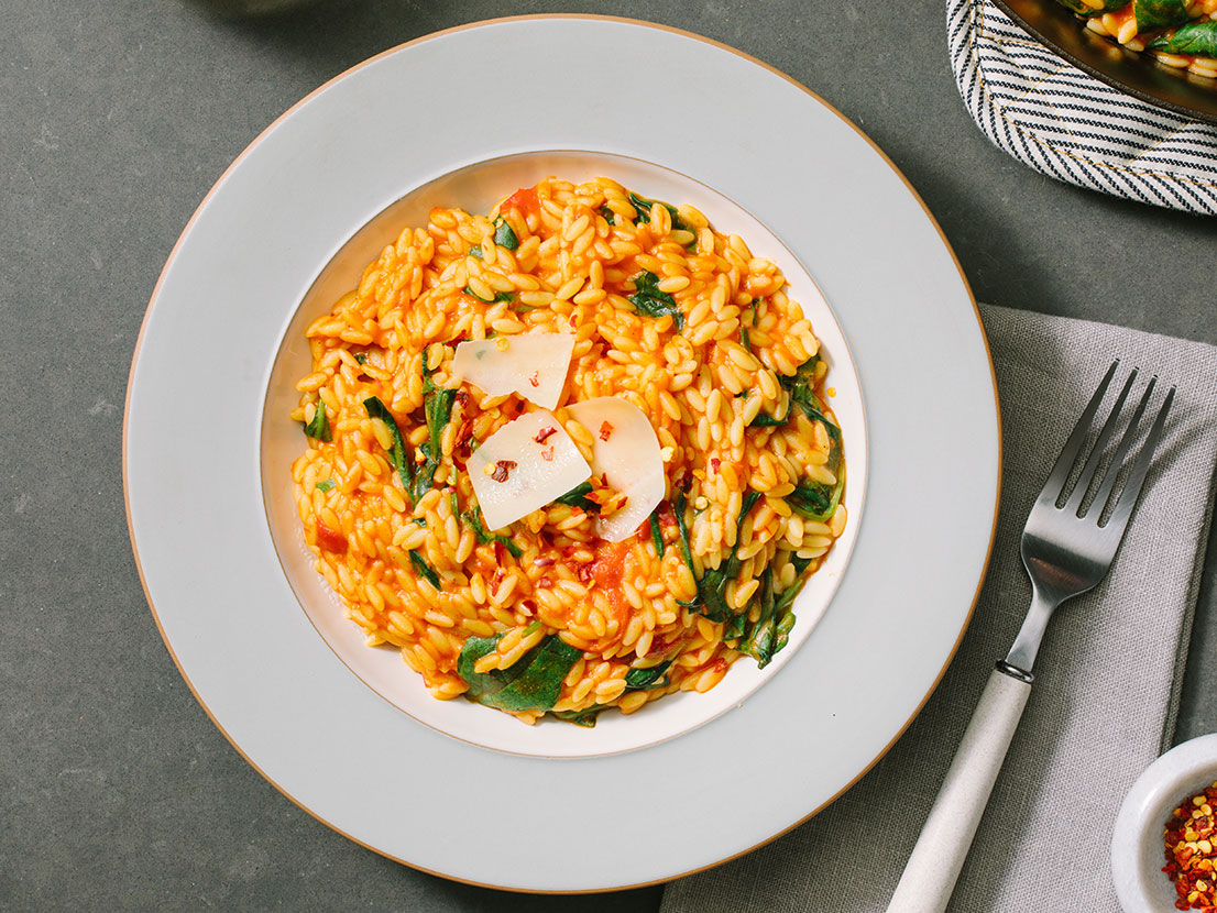 An image of prepared Creamy Tomato Ricotta Orzo Skillet made with Prego® Creamy Tomato with Ricotta Sauce.