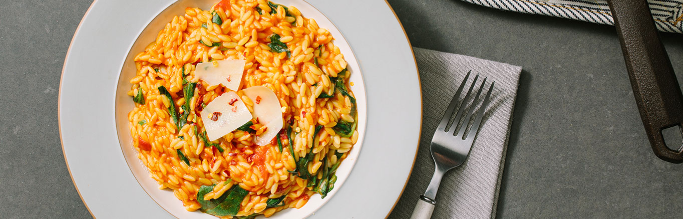 An image of prepared Creamy Tomato Ricotta Orzo Skillet made with Prego® Creamy Tomato with Ricotta Sauce.
