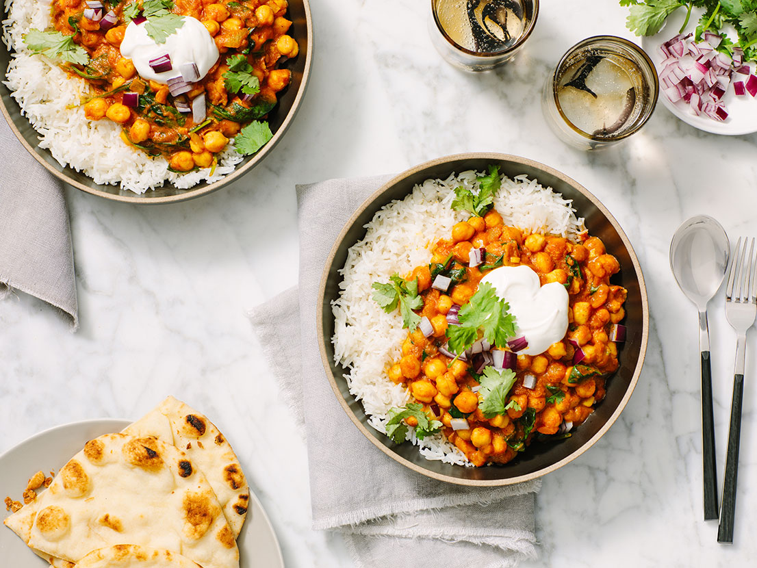 An image of prepared Easy Chickpea & Spinach Curry made with Prego® Creamy Tomato with Garlic Sauce, onion, curry powder, chickpeas, baby spinach and cilantro.
