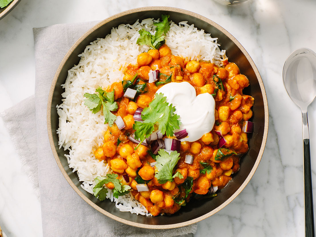 An image of prepared Easy Chickpea & Spinach Curry made with Prego® Creamy Tomato with Garlic Sauce, onion, curry powder, chickpeas, baby spinach and cilantro.