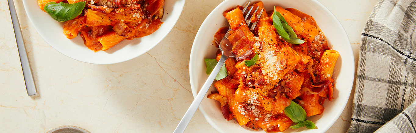 An image of prepared Spicy Rigatoni Vodka made with Prego® Spicy Vodka Sauce, rigatoni, bacon, onion and garlic.