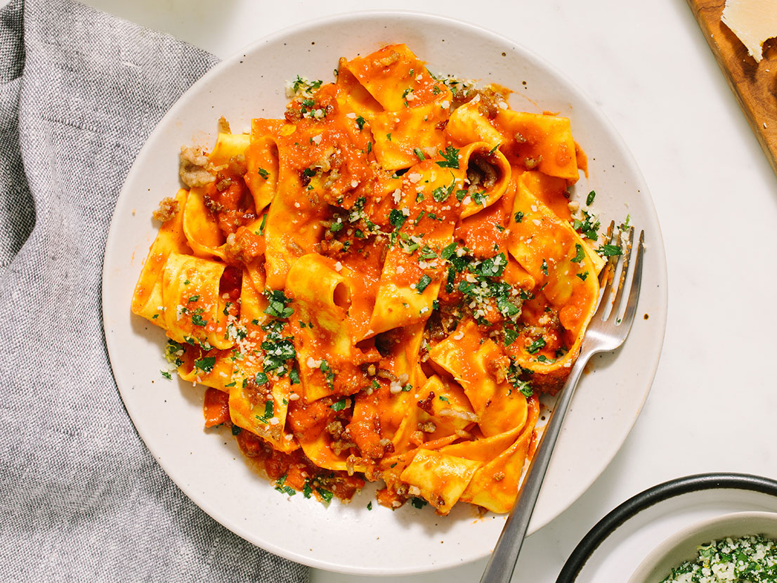 An image of prepared Spicy Vodka & Sausage Pappardelle made with Prego® Spicy Vodka Sauce, Parmesan cheese, parsley, Italian pork sausage and garlic.
