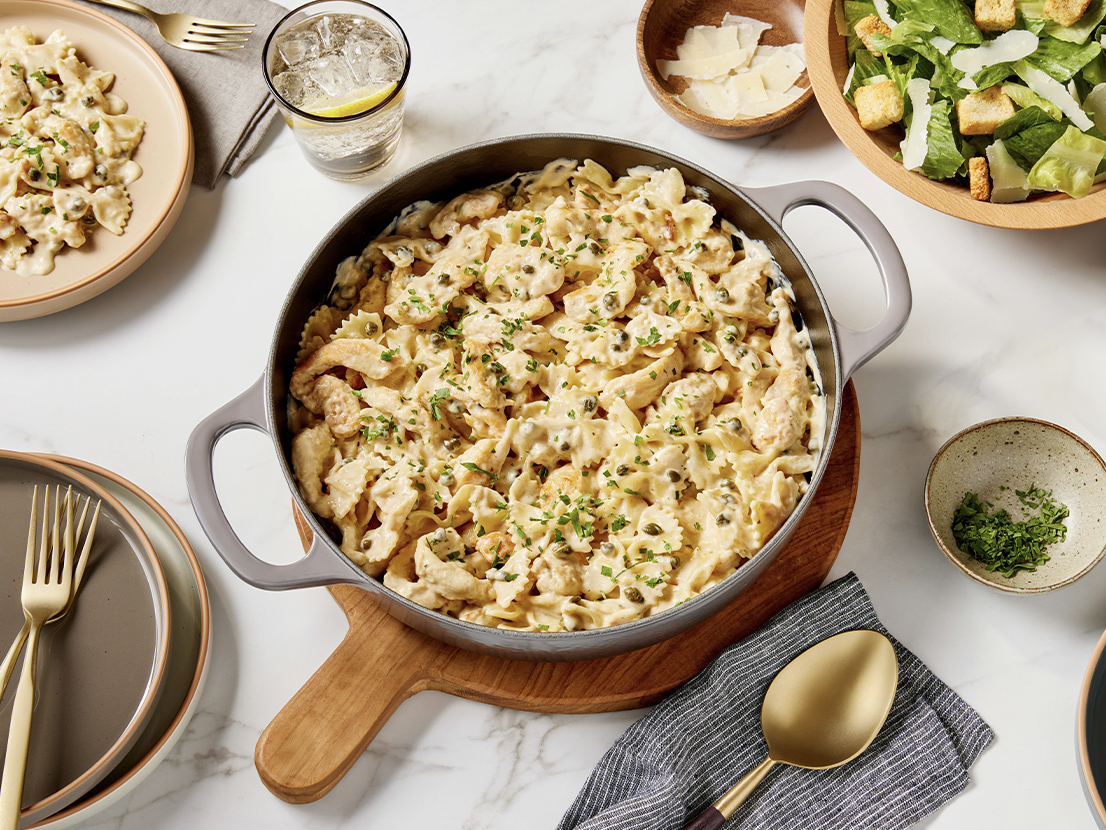 An image of prepare Chicken Piccata Pasta made with farfalle (bow tie) pasta, chicken breast, white wine, Prego® Lemon Alfredo Sauce and capers.