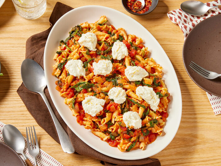 An image of prepared Tomato & Spinach Pasta with Lemon Ricotta made with Prego® Margherita Sauce, pasta, spinach, ricotta and lemon.